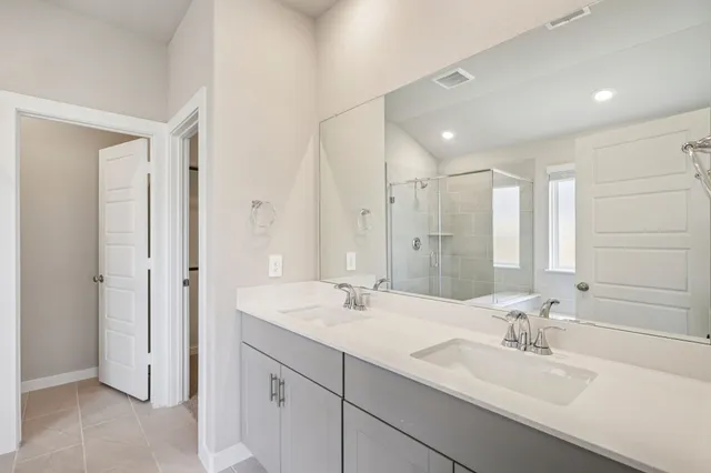 a bathroom with a double vanity sink mirror and double