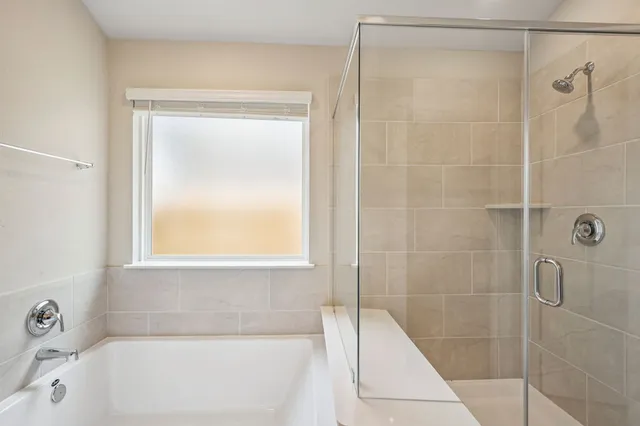 a bathroom with a bathtub and a shower