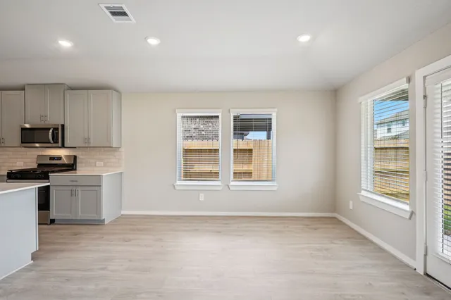 a view of a kitchen with a sink dishwasher and a refrigerator