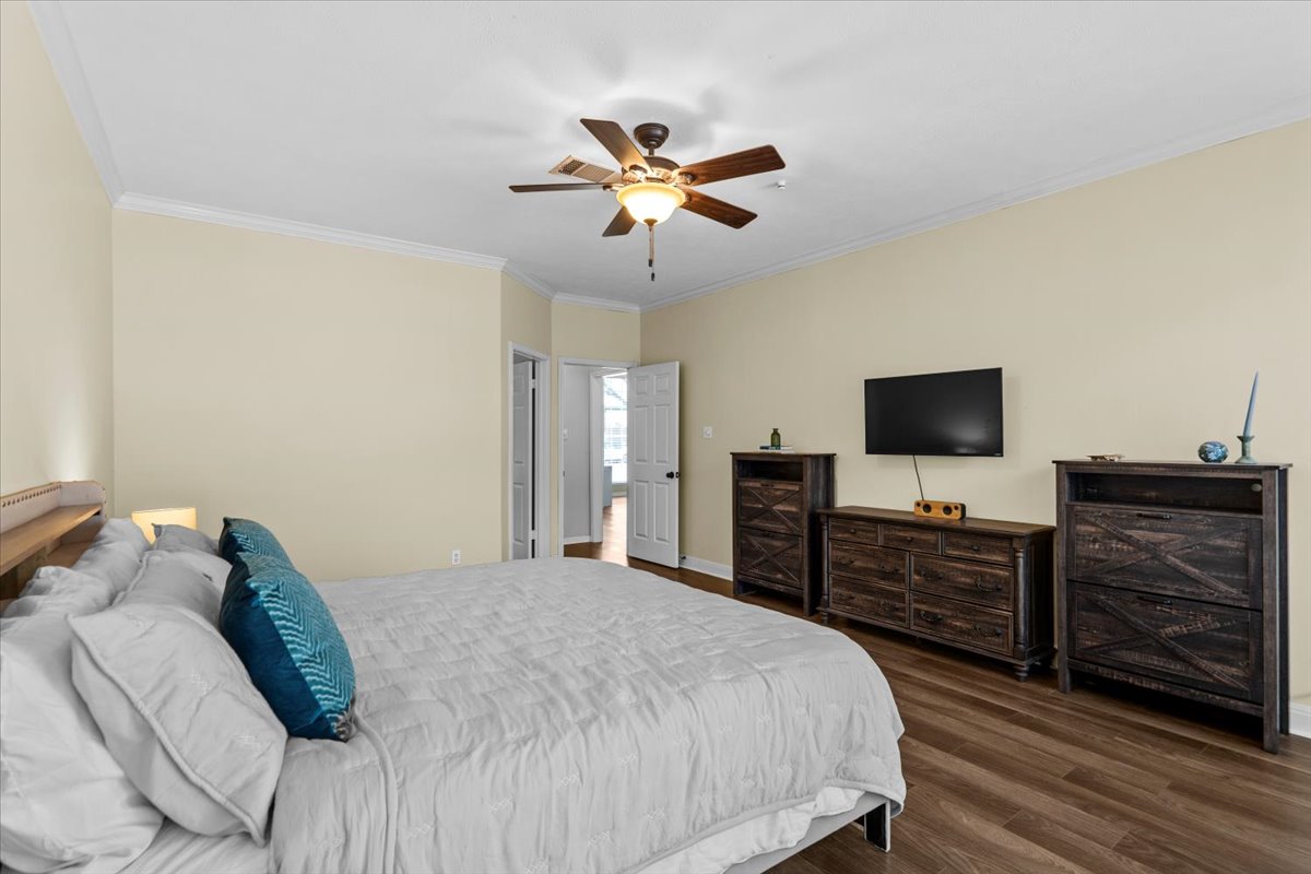 10116 Pinehurst Drive Austin, TX 78747 - Photo 30 of 37 Bedroom featuring crown molding, wood finished floors, and a ceiling fan