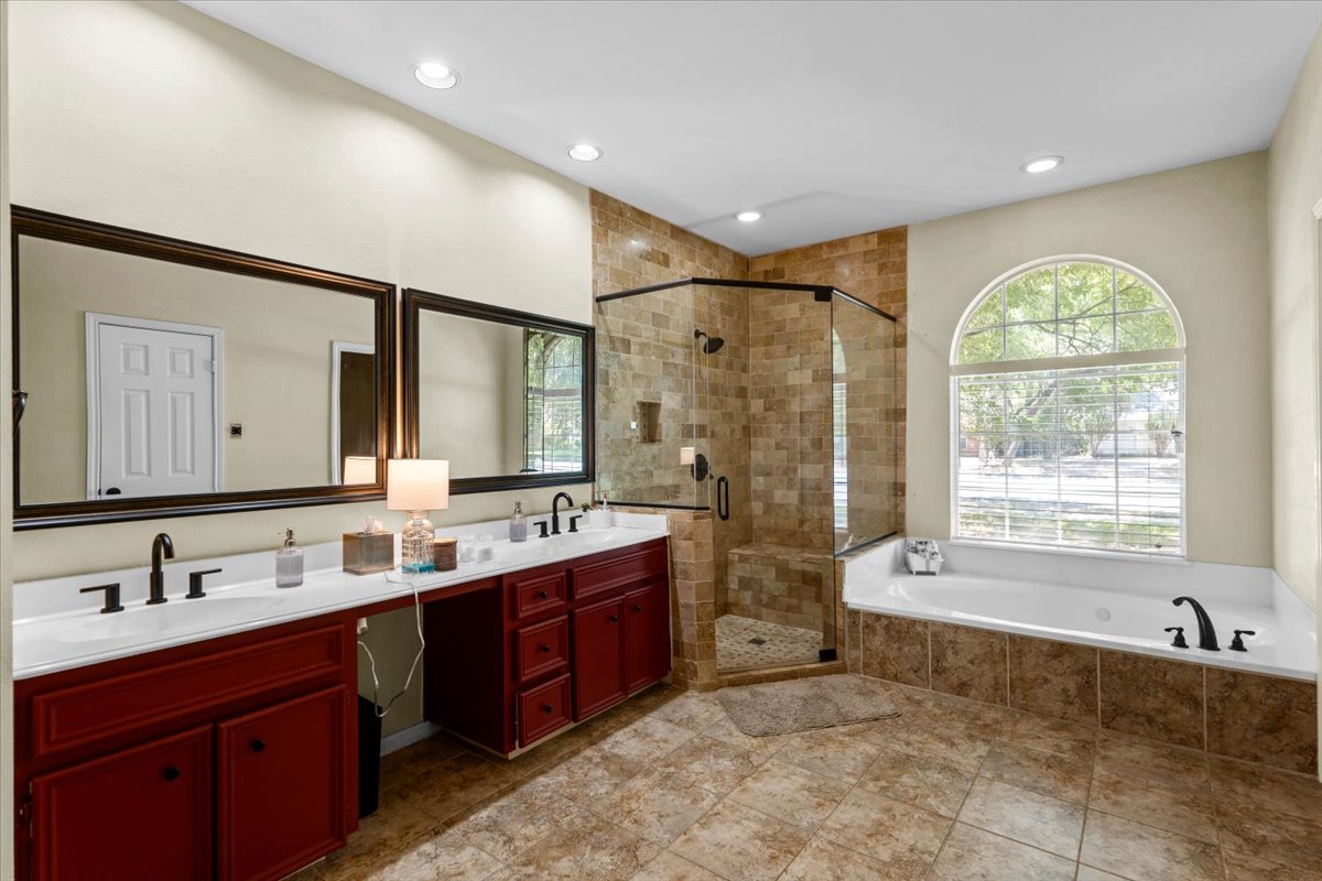 10116 Pinehurst Drive Austin, TX 78747 - Photo 31 of 37 Bathroom featuring double vanity, a stall shower, a garden tub, recessed lighting, and tile patterned floors