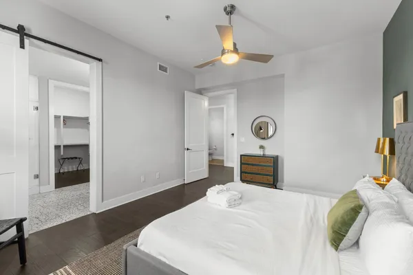 a bedroom with a bed and a chandelier