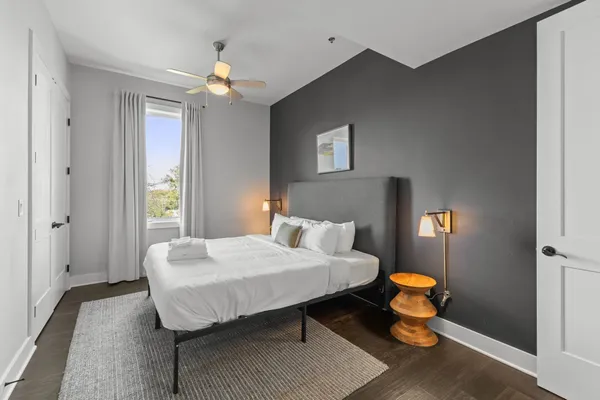 a bedroom with a bed and a lamp with window