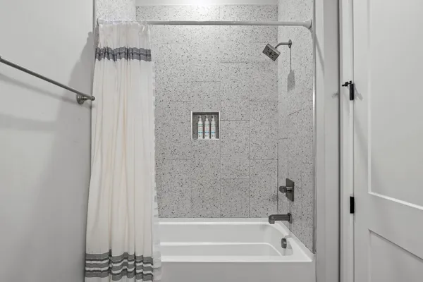 a bathroom with a bathtub and a shower
