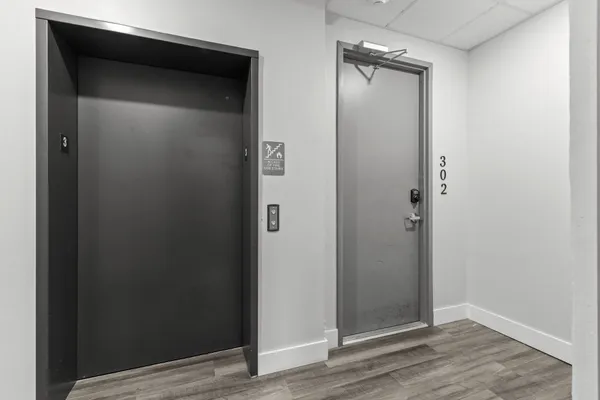 an empty room with wooden floor and closet
