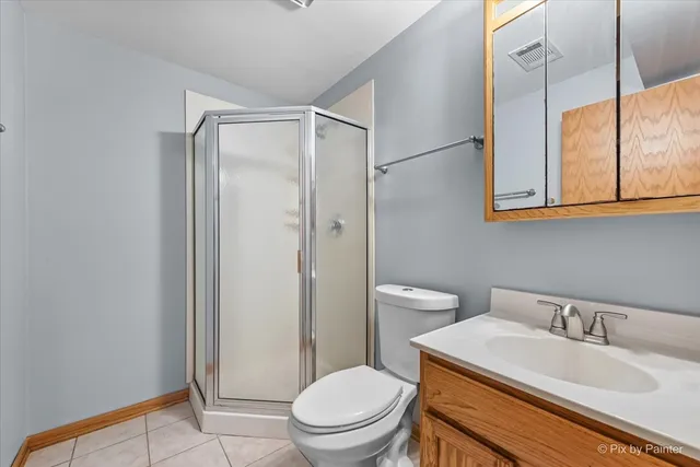 a bathroom with a granite countertop sink toilet a mirror and shower