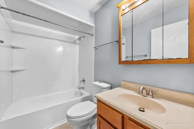 a bathroom with a sink toilet tub and shower