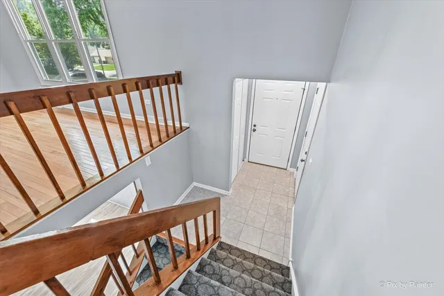 a view of staircase with railing and stairs