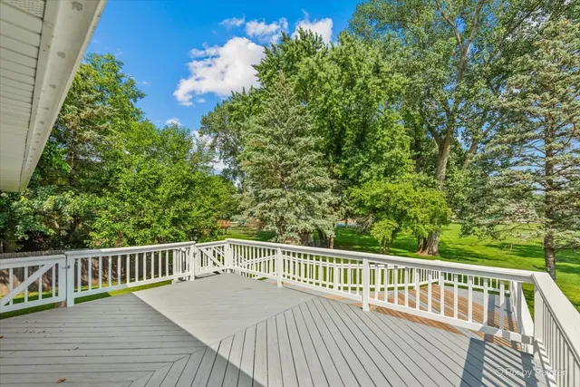 a view of balcony with wooden floor and fence
