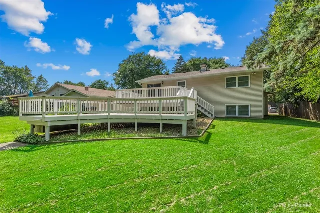 a view of a house with a backyard