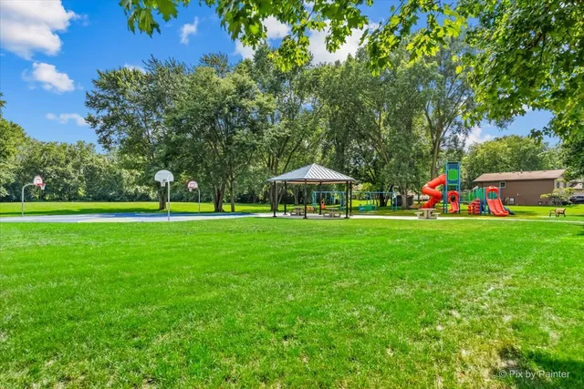 a view of green field with house in the background