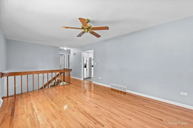 a view of room with wooden floor and white walls