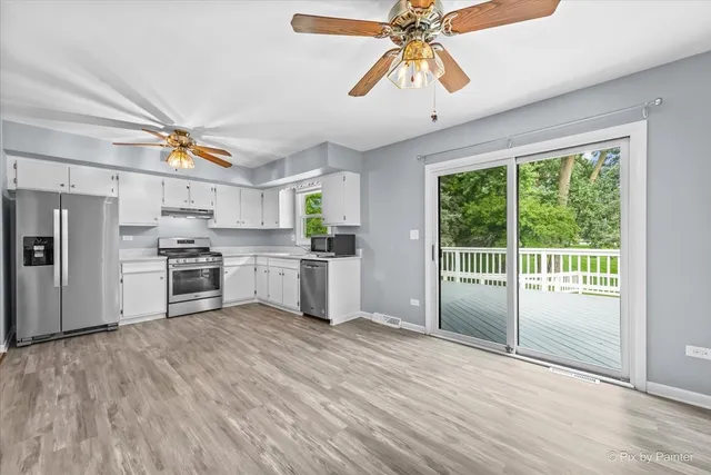 a kitchen with stainless steel appliances kitchen island granite countertop a stove a sink and a refrigerator