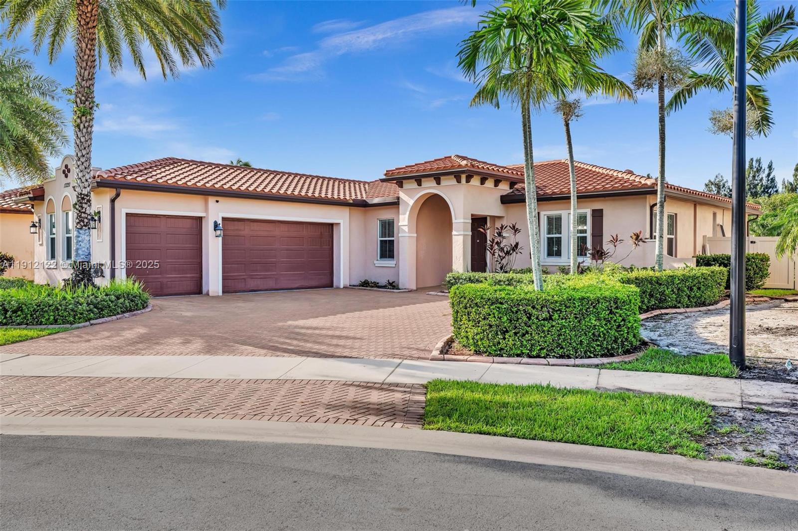13220 Southwest 13th Street Davie, FL 33325 - Photo 1 of 65 a front view of a house with a garden