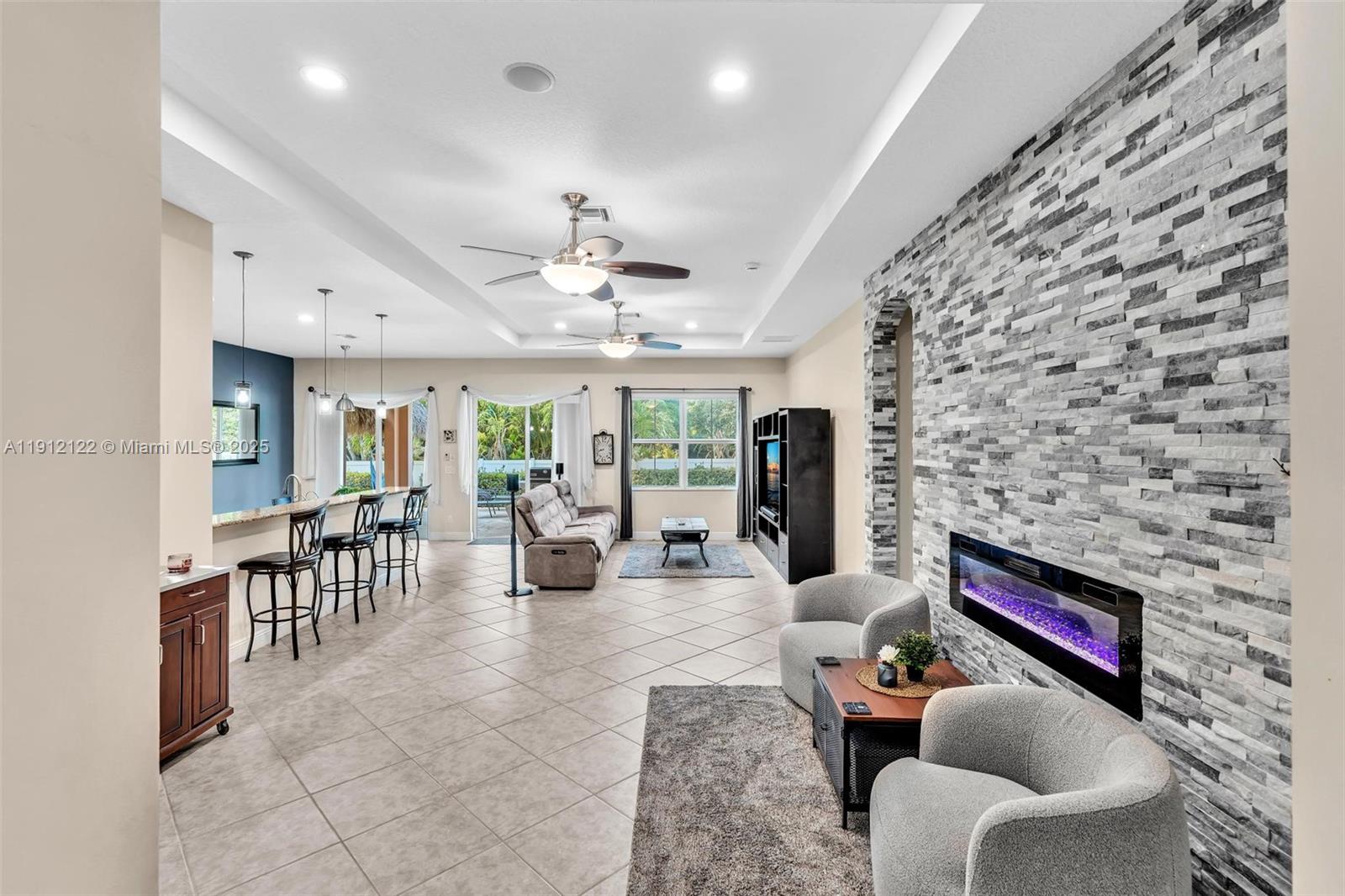 13220 Southwest 13th Street Davie, FL 33325 - Photo 12 of 65 a living room with furniture and a chandelier