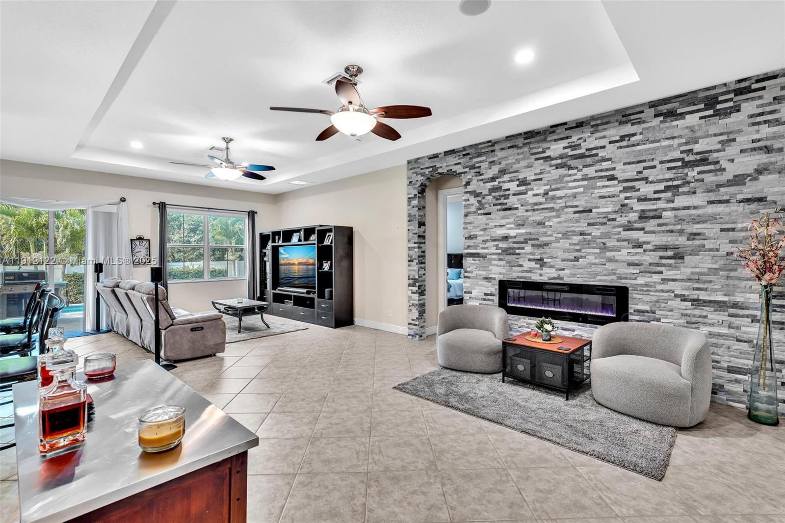 13220 Southwest 13th Street Davie, FL 33325 - Photo 14 of 65 a living room with furniture and a fireplace