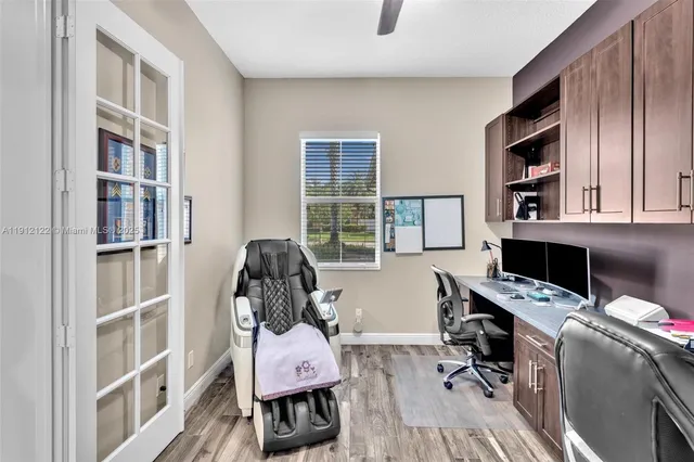 a living room with furniture a flat screen tv and a floor to ceiling window