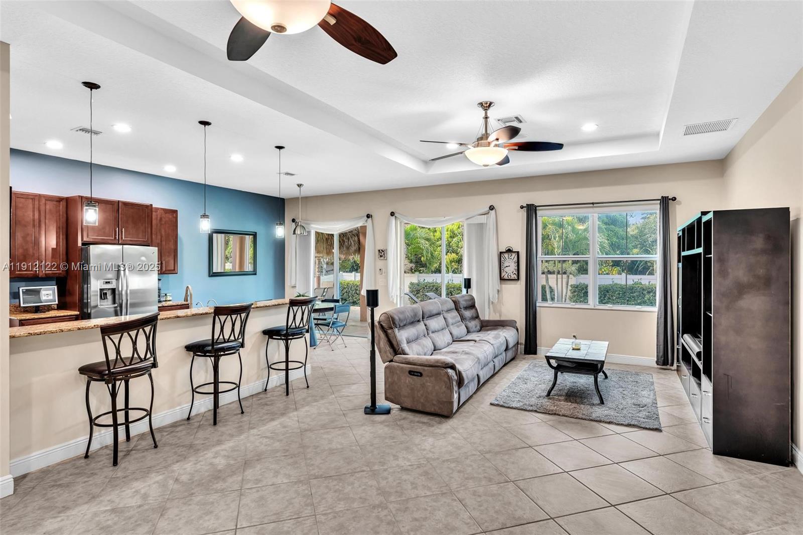13220 Southwest 13th Street Davie, FL 33325 - Photo 19 of 65 a living room with furniture a ceiling fan and a window