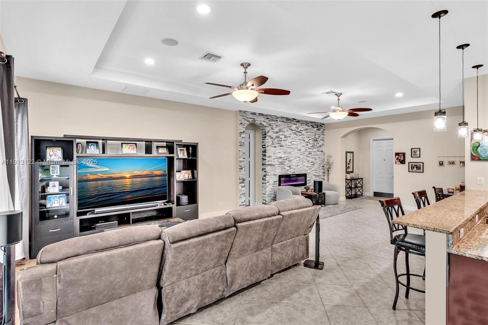 13220 Southwest 13th Street Davie, FL 33325 - Photo 23 of 65 a living room with furniture and a flat screen tv