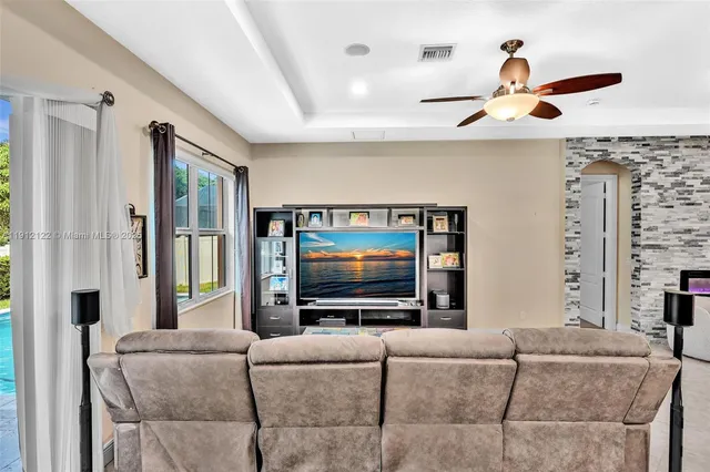 a kitchen with kitchen island granite countertop a sink and a large window