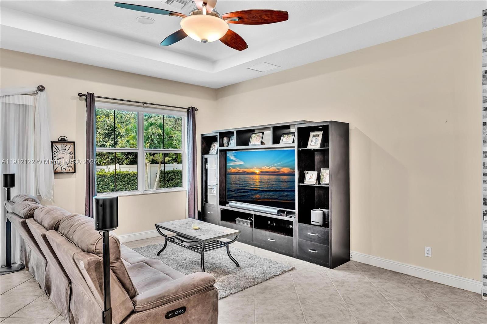13220 Southwest 13th Street Davie, FL 33325 - Photo 25 of 65 a living room with furniture and a flat screen tv