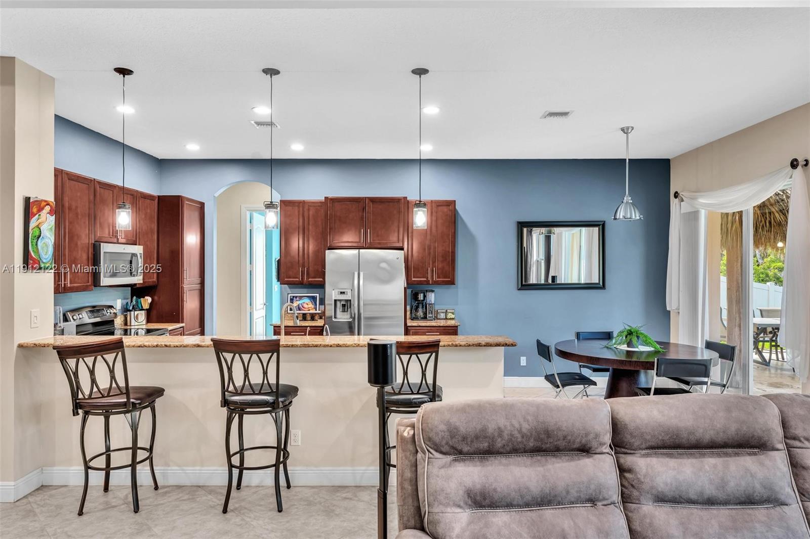 13220 Southwest 13th Street Davie, FL 33325 - Photo 26 of 65 a living room with furniture kitchen view and a wooden floor