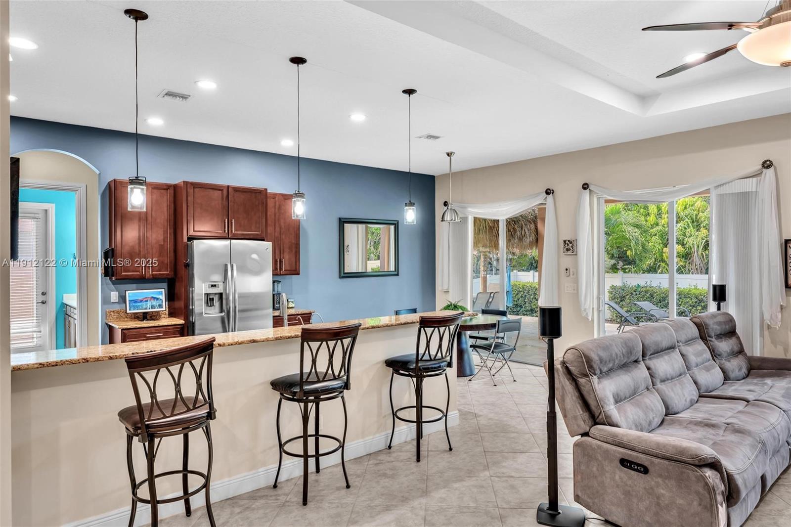 13220 Southwest 13th Street Davie, FL 33325 - Photo 28 of 65 a living room with furniture kitchen area and a large window