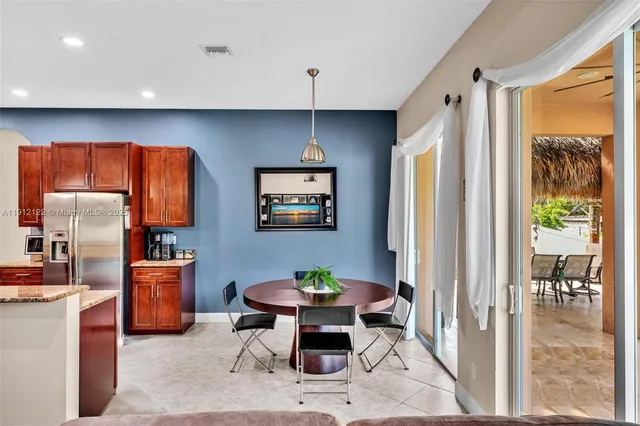 a bathroom with a granite countertop tub sink and mirror