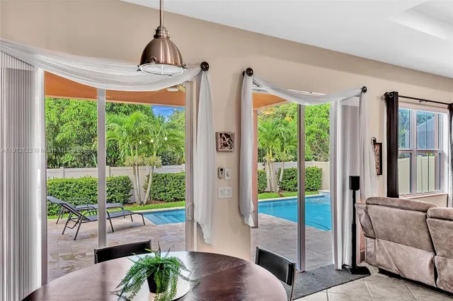 a bathroom with a granite countertop tub sink and mirror