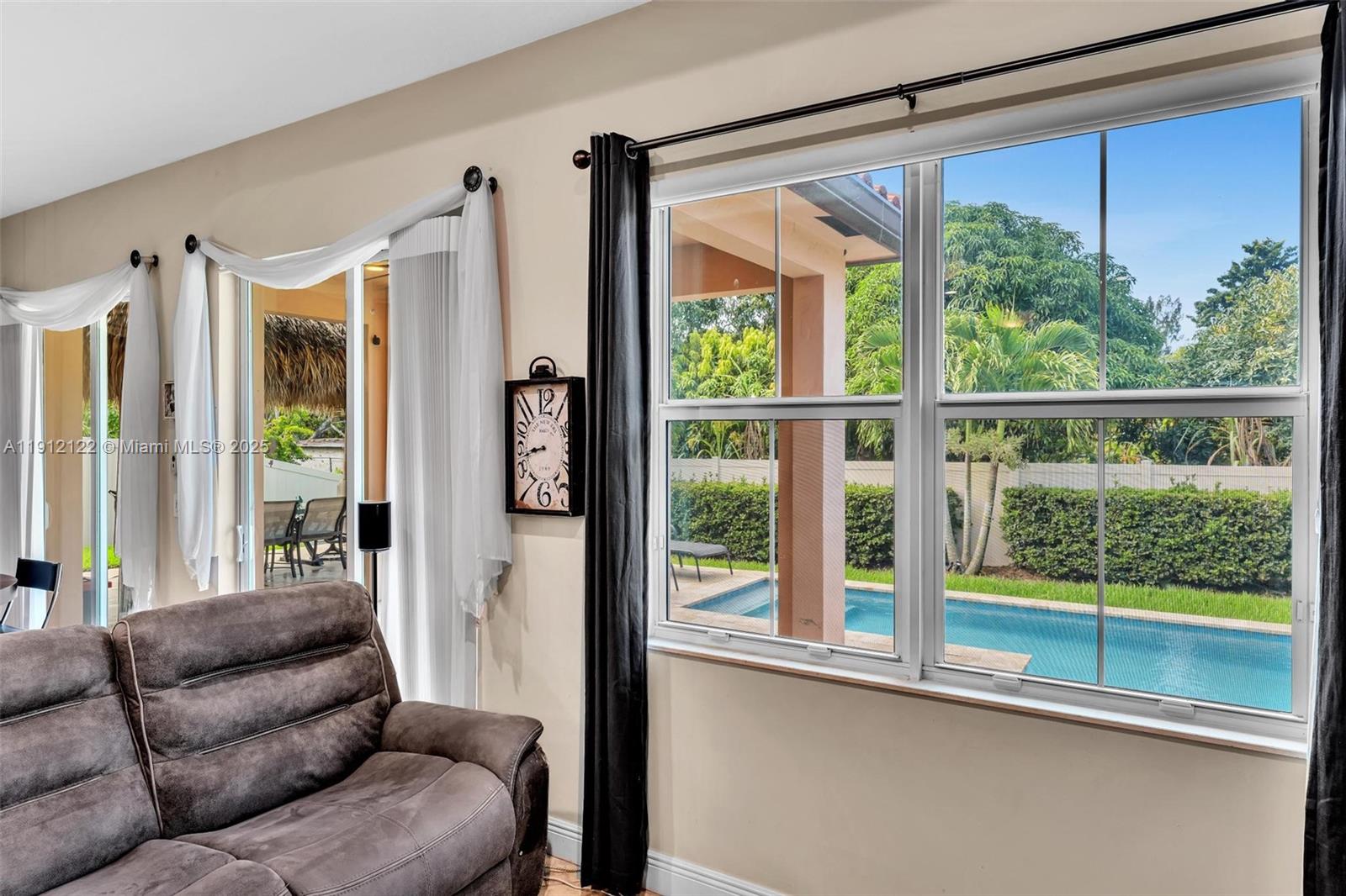 13220 Southwest 13th Street Davie, FL 33325 - Photo 36 of 65 a living room with furniture and a large window