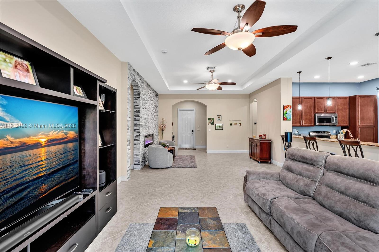 13220 Southwest 13th Street Davie, FL 33325 - Photo 37 of 65 a living room with furniture and a flat screen tv