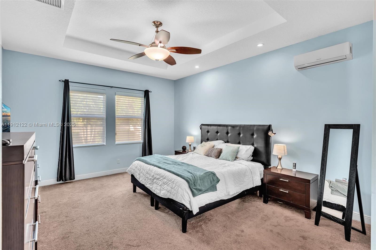 13220 Southwest 13th Street Davie, FL 33325 - Photo 38 of 65 a bedroom with a bed and a chandelier