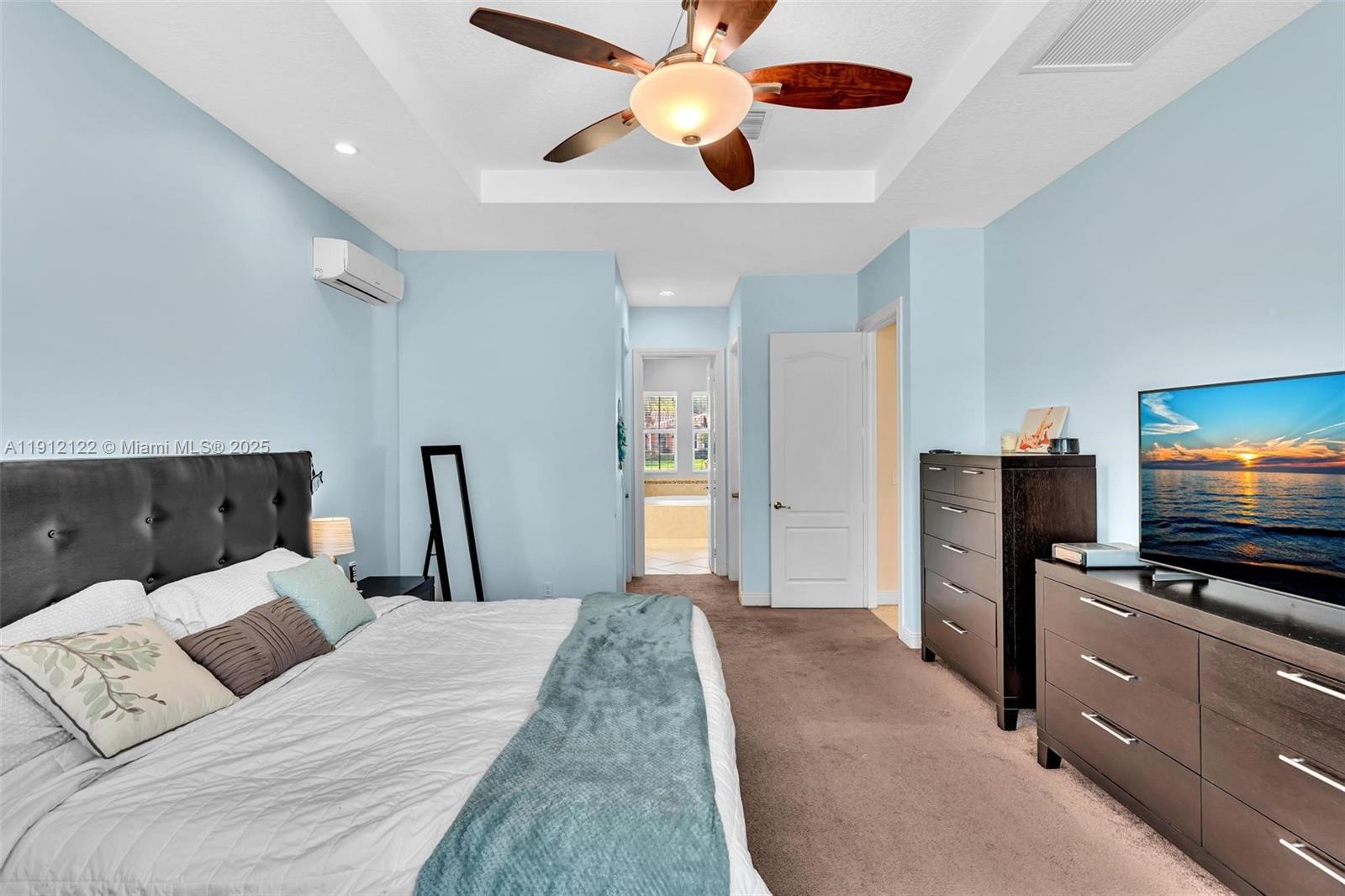 13220 Southwest 13th Street Davie, FL 33325 - Photo 40 of 65 a bedroom with a bed and a flat screen tv