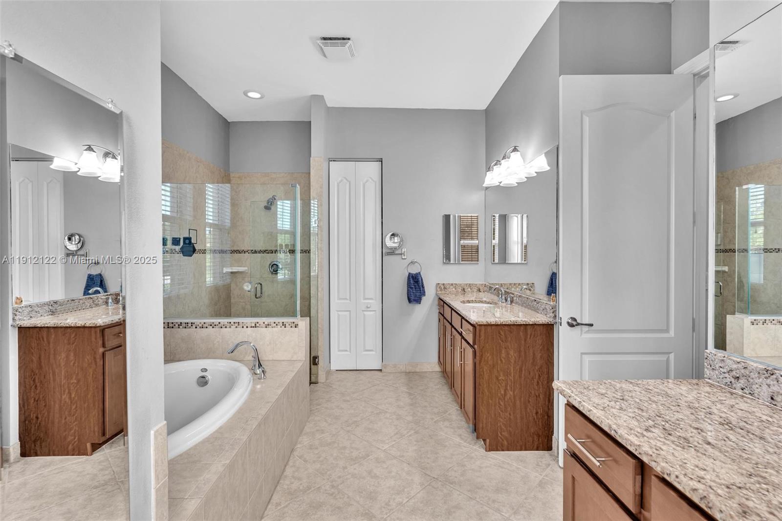 13220 Southwest 13th Street Davie, FL 33325 - Photo 43 of 65 a bathroom with a granite countertop tub sink and mirror