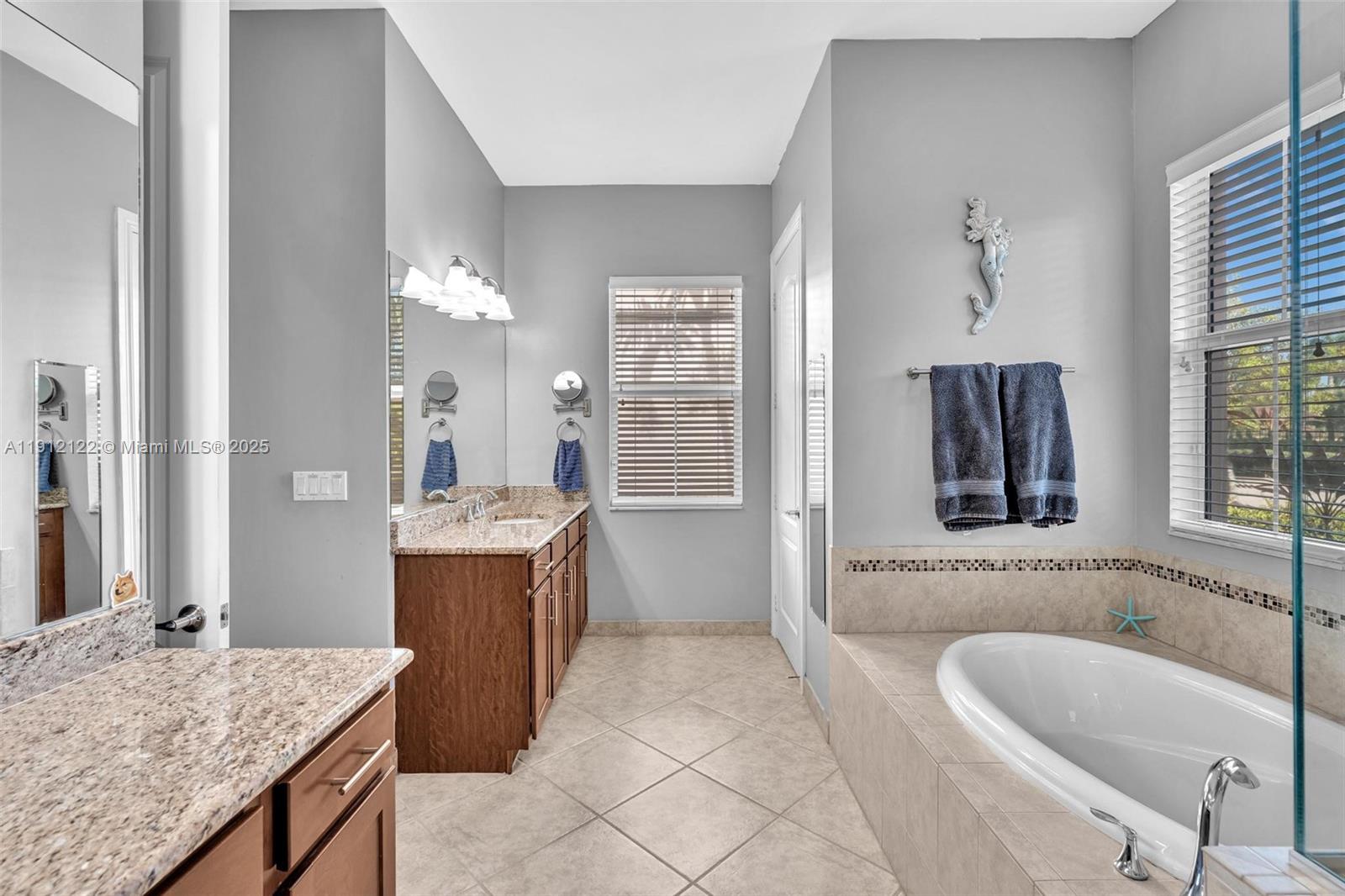 13220 Southwest 13th Street Davie, FL 33325 - Photo 44 of 65 a bathroom with a granite countertop tub sink and mirror