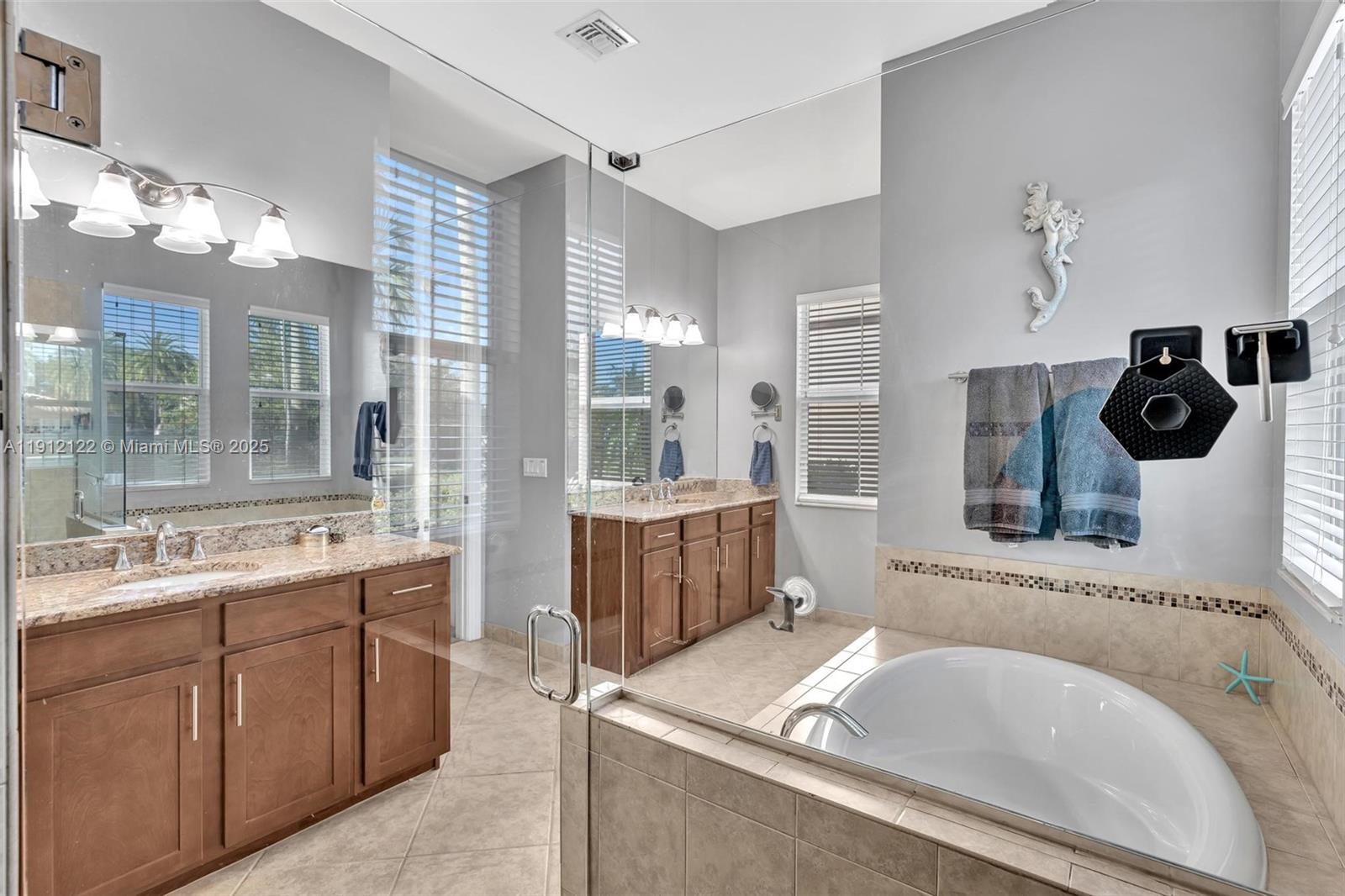 13220 Southwest 13th Street Davie, FL 33325 - Photo 45 of 65 a bathroom with a tub sink and mirror
