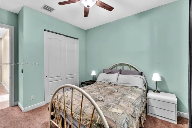 a front view of a house with a garden and yard