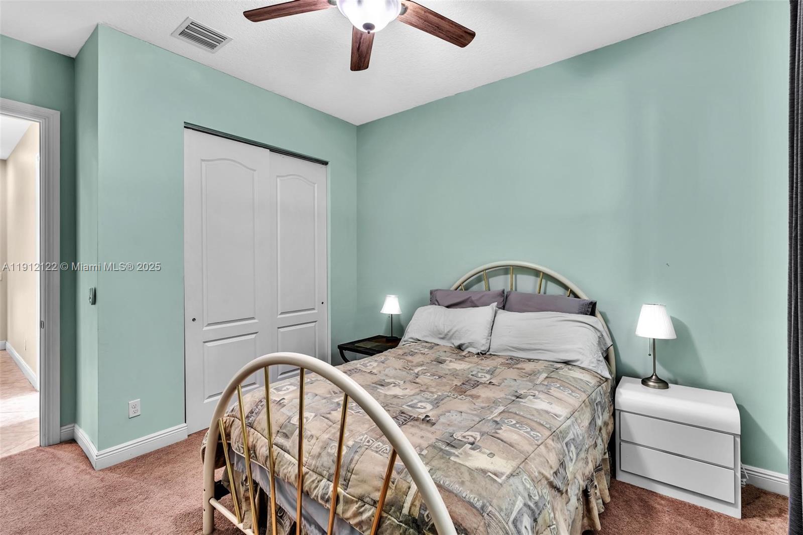 13220 Southwest 13th Street Davie, FL 33325 - Photo 46 of 65 a bedroom with a bed and a chandelier