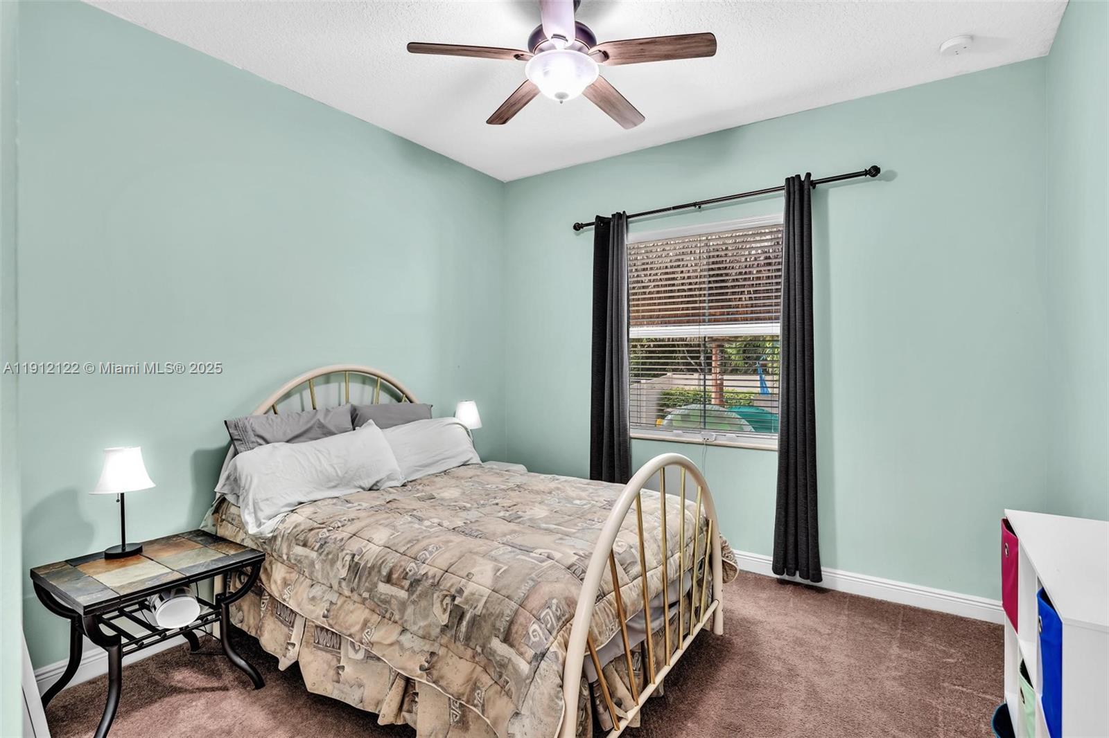 13220 Southwest 13th Street Davie, FL 33325 - Photo 47 of 65 a bedroom with a bed and window