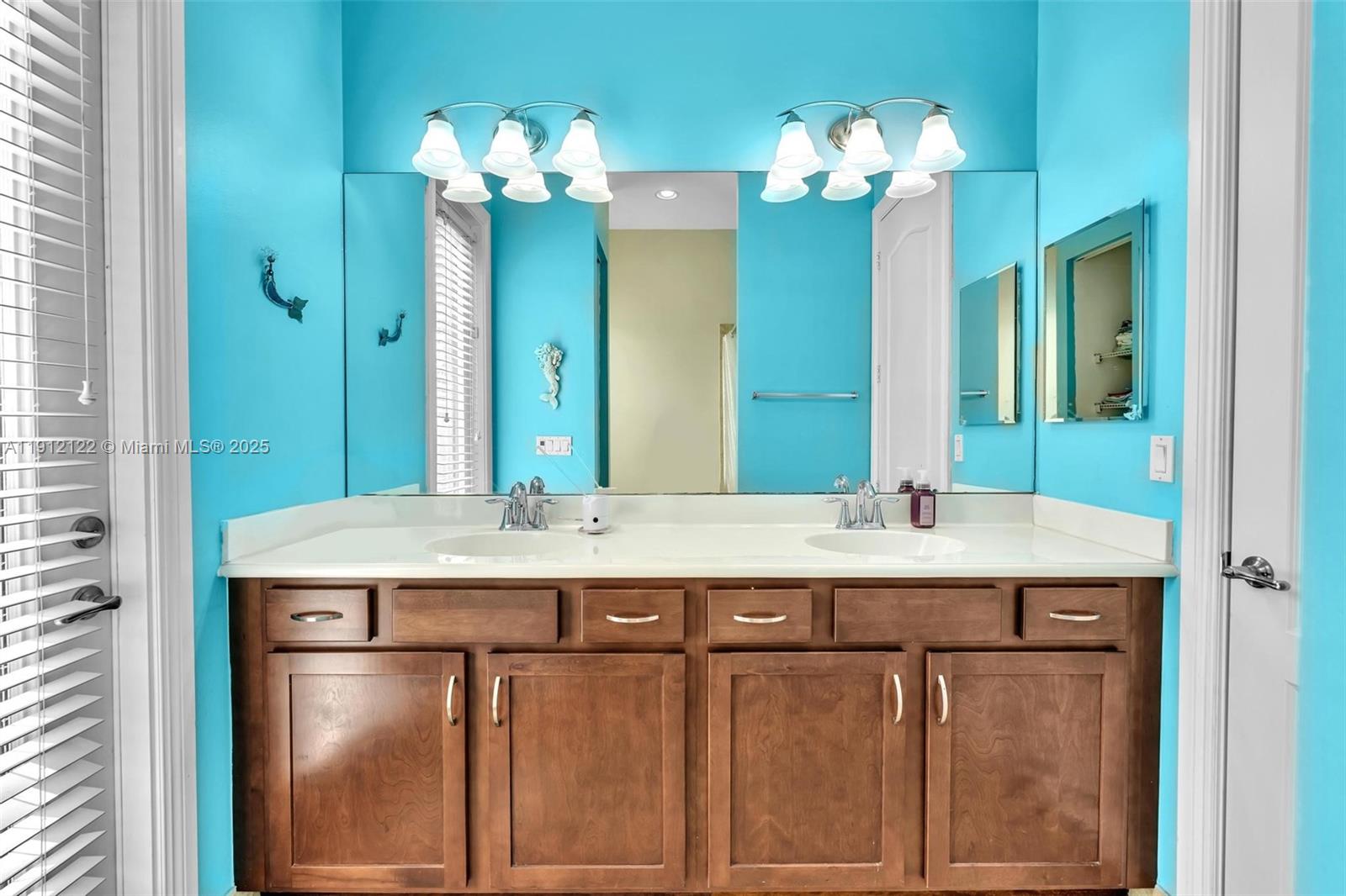 13220 Southwest 13th Street Davie, FL 33325 - Photo 49 of 65 a bathroom with a double vanity sink and a mirror