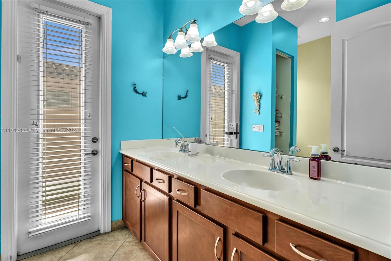 13220 Southwest 13th Street Davie, FL 33325 - Photo 50 of 65 a bathroom with a sink double vanity and a mirror