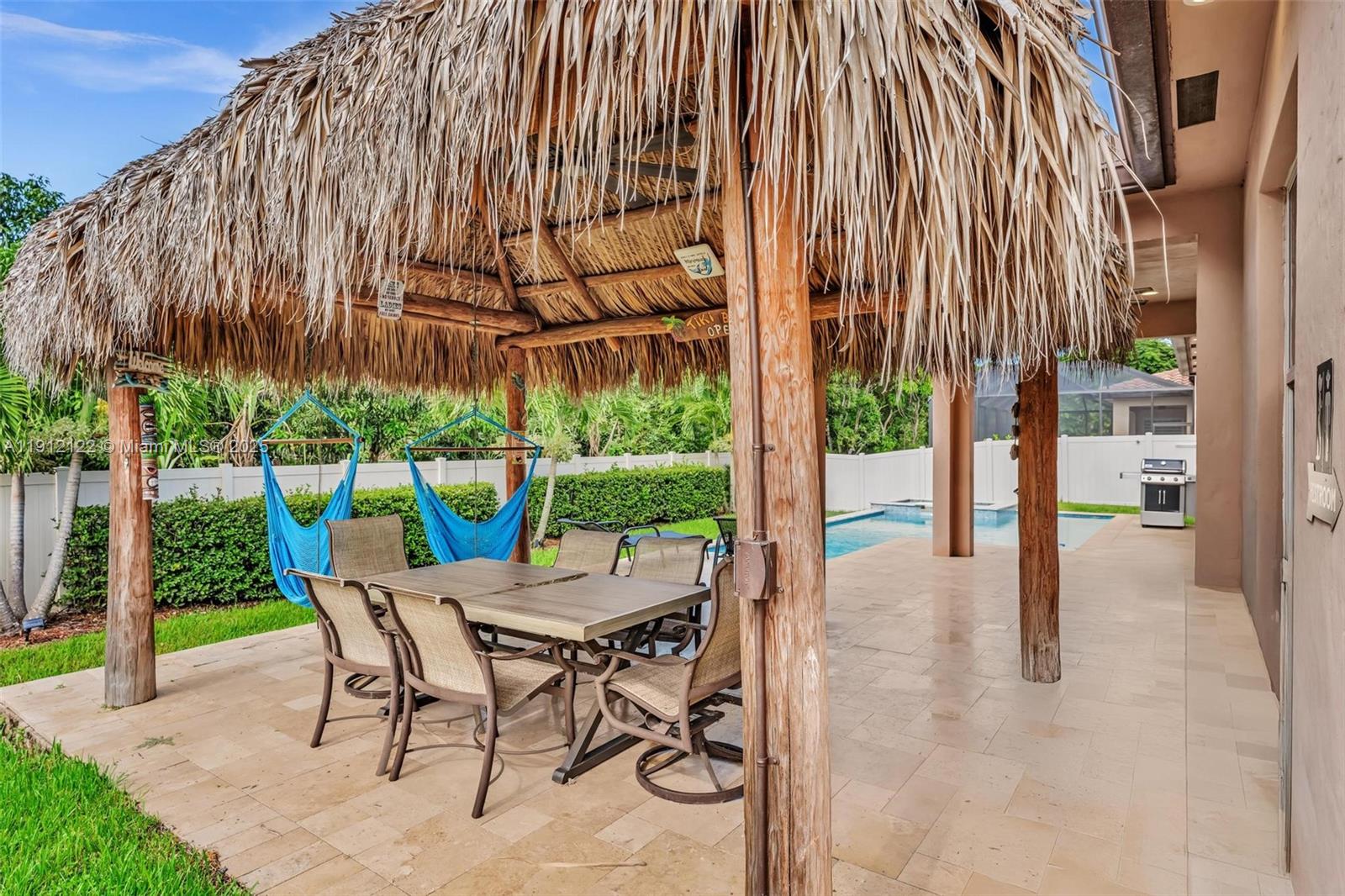 13220 Southwest 13th Street Davie, FL 33325 - Photo 5 of 65 a patio with a yard table and chairs