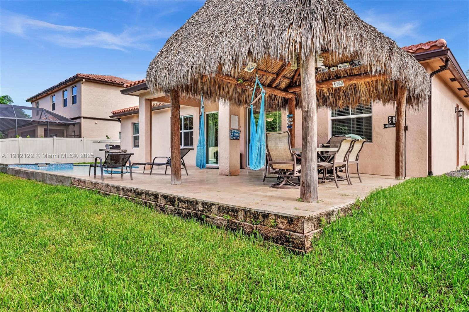 13220 Southwest 13th Street Davie, FL 33325 - Photo 55 of 65 a view of a building with a yard and sitting area