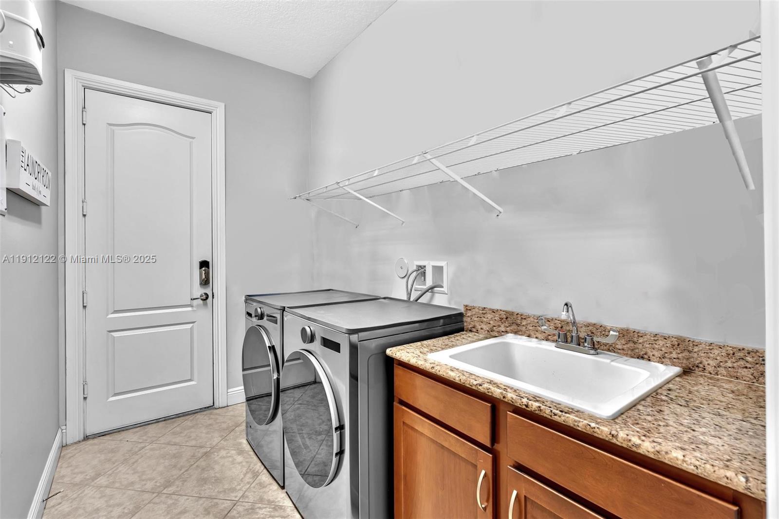 13220 Southwest 13th Street Davie, FL 33325 - Photo 59 of 65 a utility room with sink dryer and washer