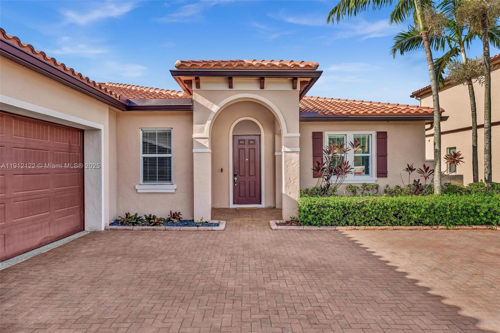 13220 Southwest 13th Street Davie, FL 33325 - Photo 7 of 65 a front view of a house with a garden