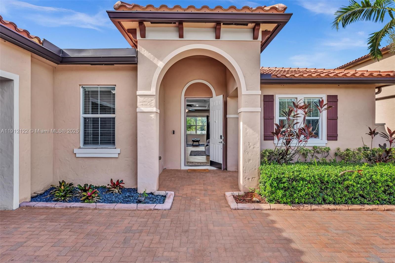 13220 Southwest 13th Street Davie, FL 33325 - Photo 8 of 65 front view of a house with potted plants