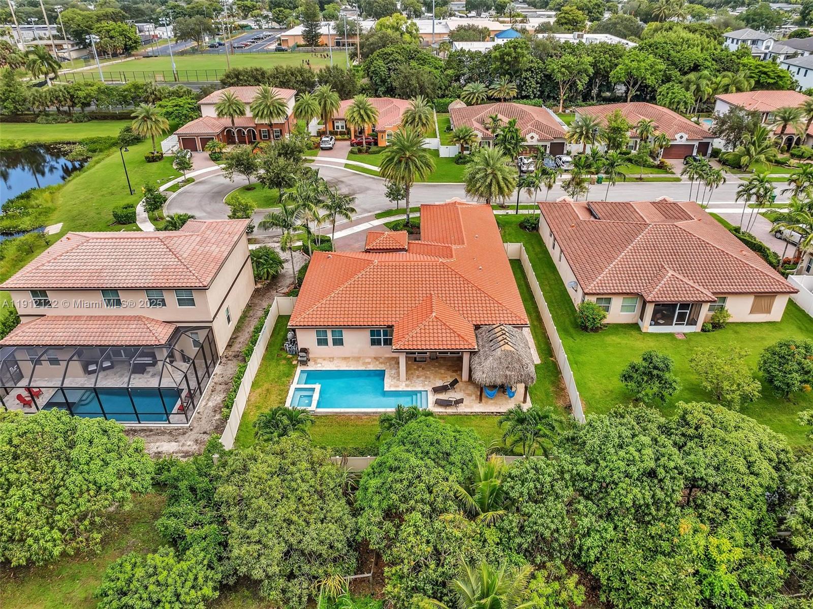 13220 Southwest 13th Street Davie, FL 33325 - Photo 10 of 65 an aerial view of multiple houses with yard