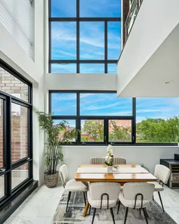 a view of a dining room with furniture window and outside view
