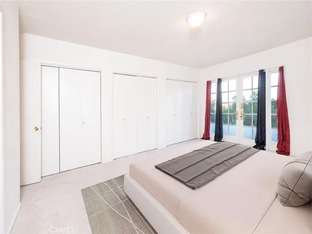 a bedroom with a bed and a large window