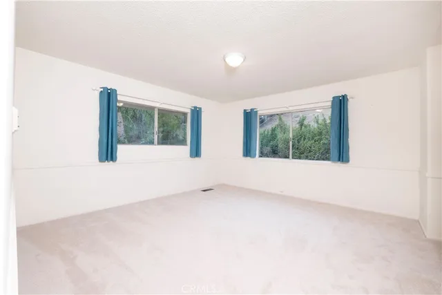 a view of a living room with bathroom